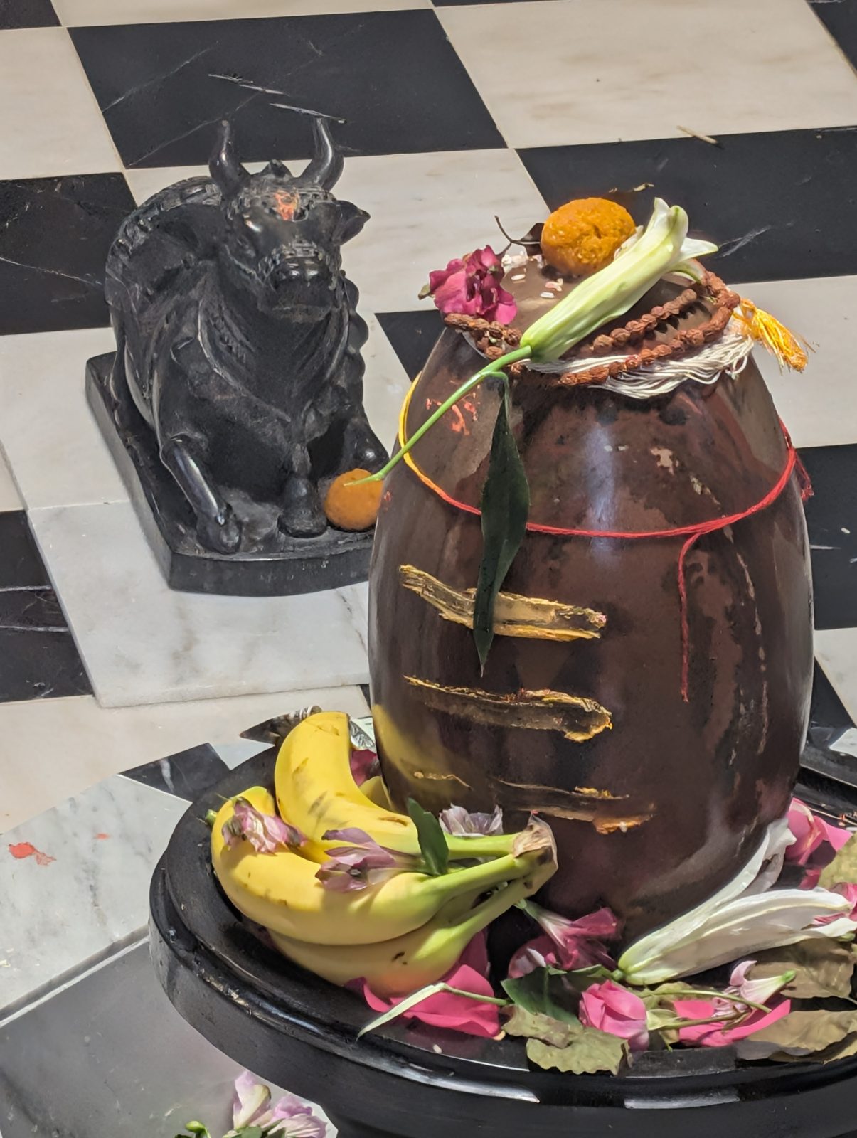 Gopeshwar Mahadev after the sacred bath — rudraksha, flowers, fruit, and Nandi keeping watch